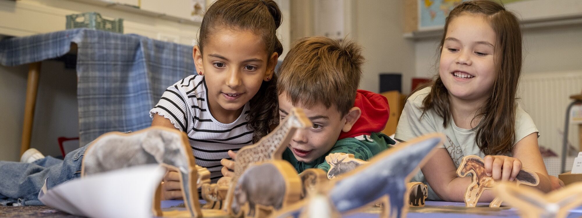 Three kids fascinated by dinosaur toys and a book 2024 03 01 16 47 29 utc