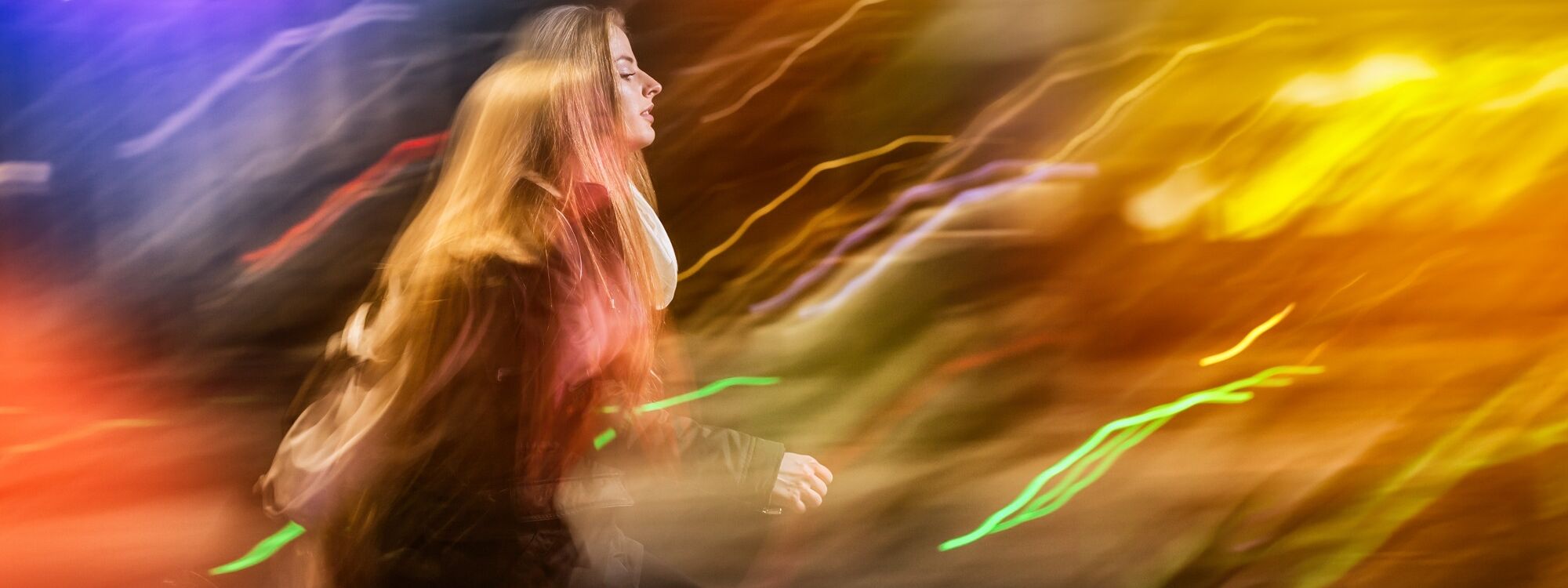 Woman in city at night among neon moving lights 2024 10 31 01 53 45 utc